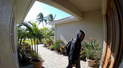 Security camera view of suspicious person approaching Florida home