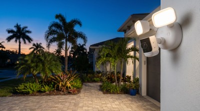 Alarm.com floodlight security camera on a modern Tampa Bay home at dusk